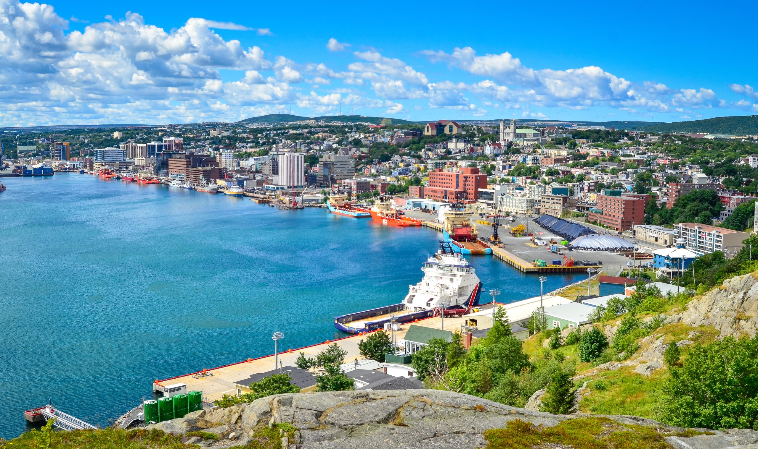 An aerial, panoramic shot of the St. John's harbour on a bright summer day.