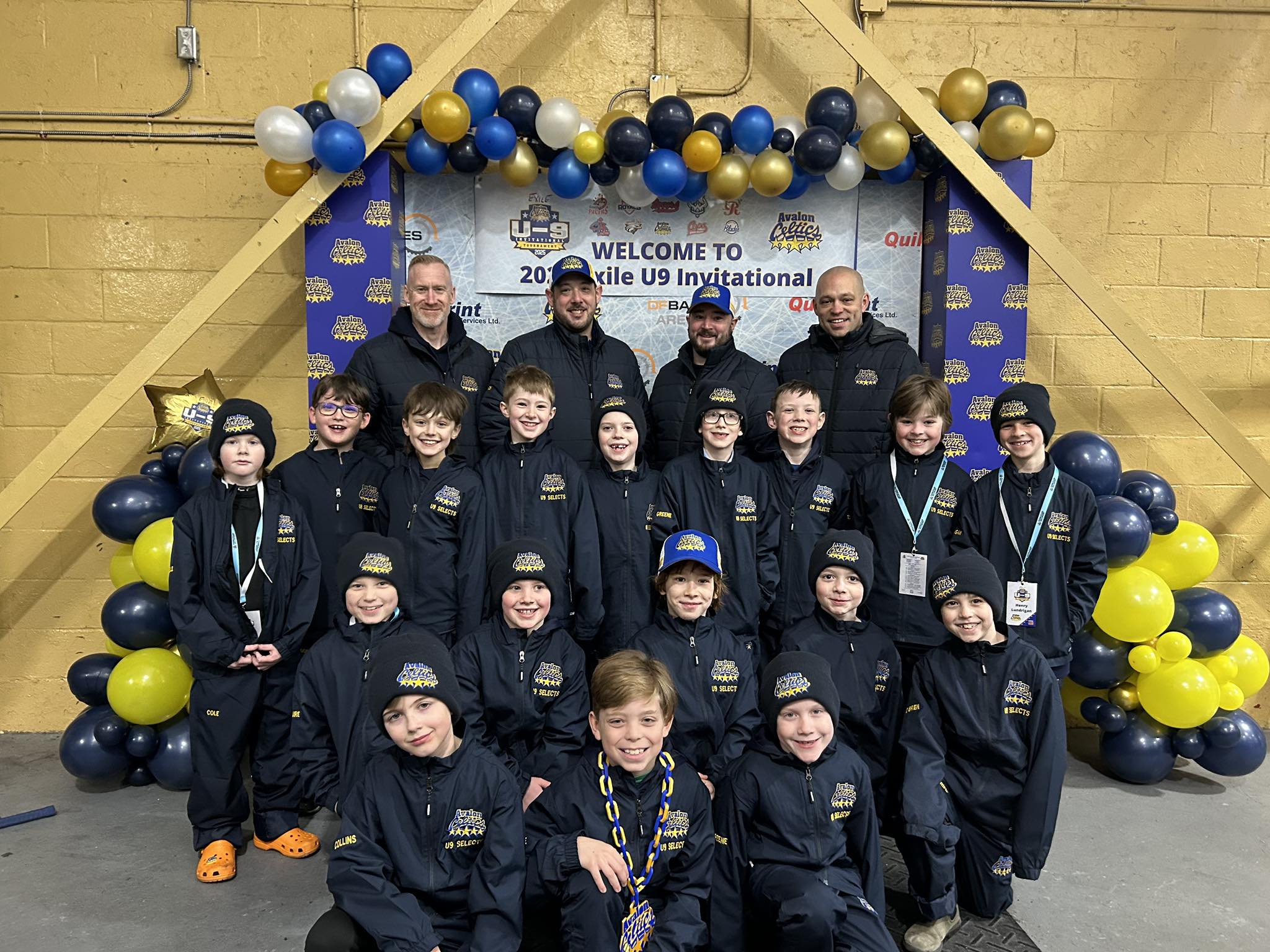 A group photo of a youth hockey teams that is sponsored by Harvey's, at the 2025 Exile U9 Invitational.