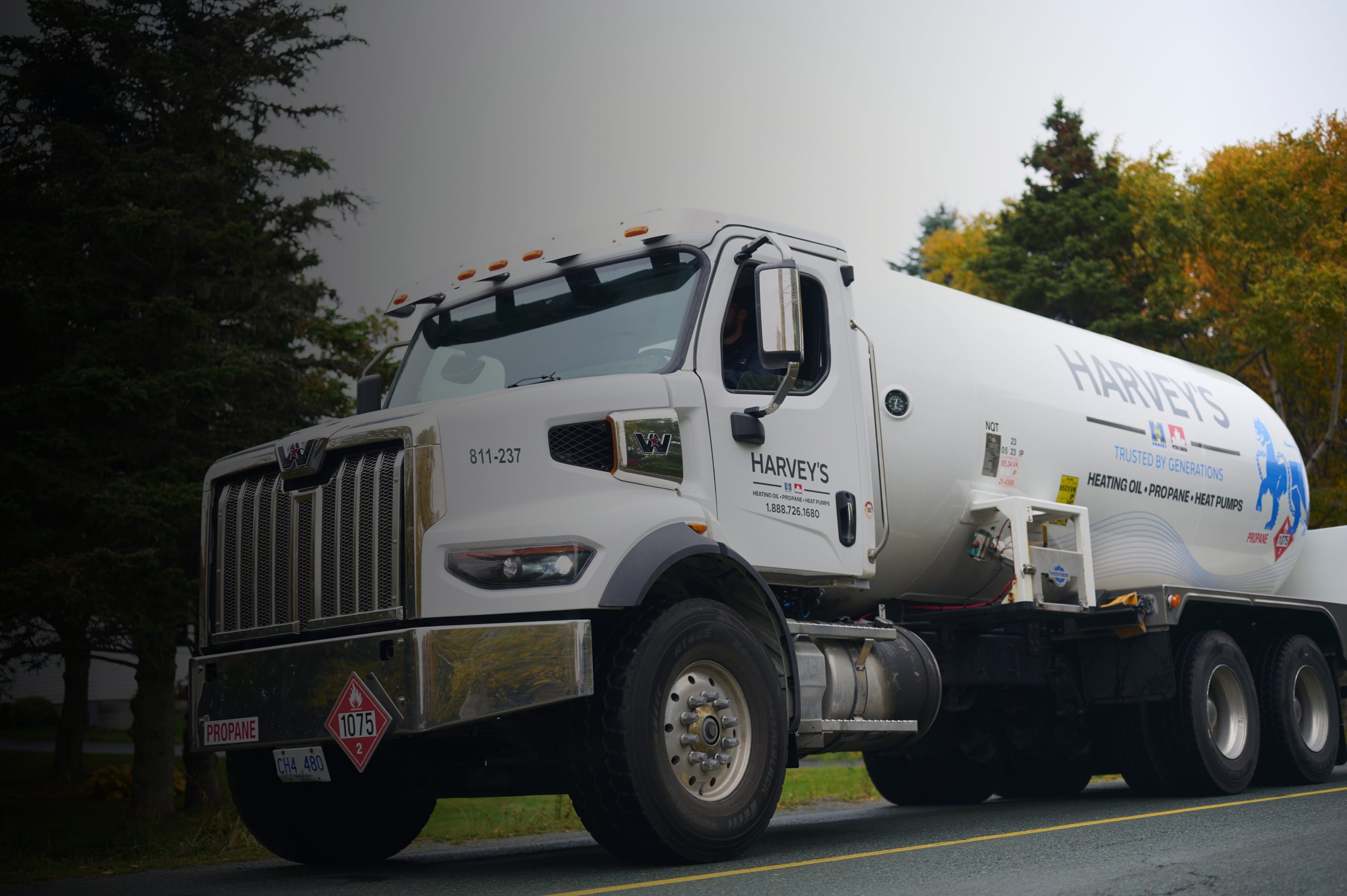 A Harvey's propane delivery truck parked in a residential neighbourhood.