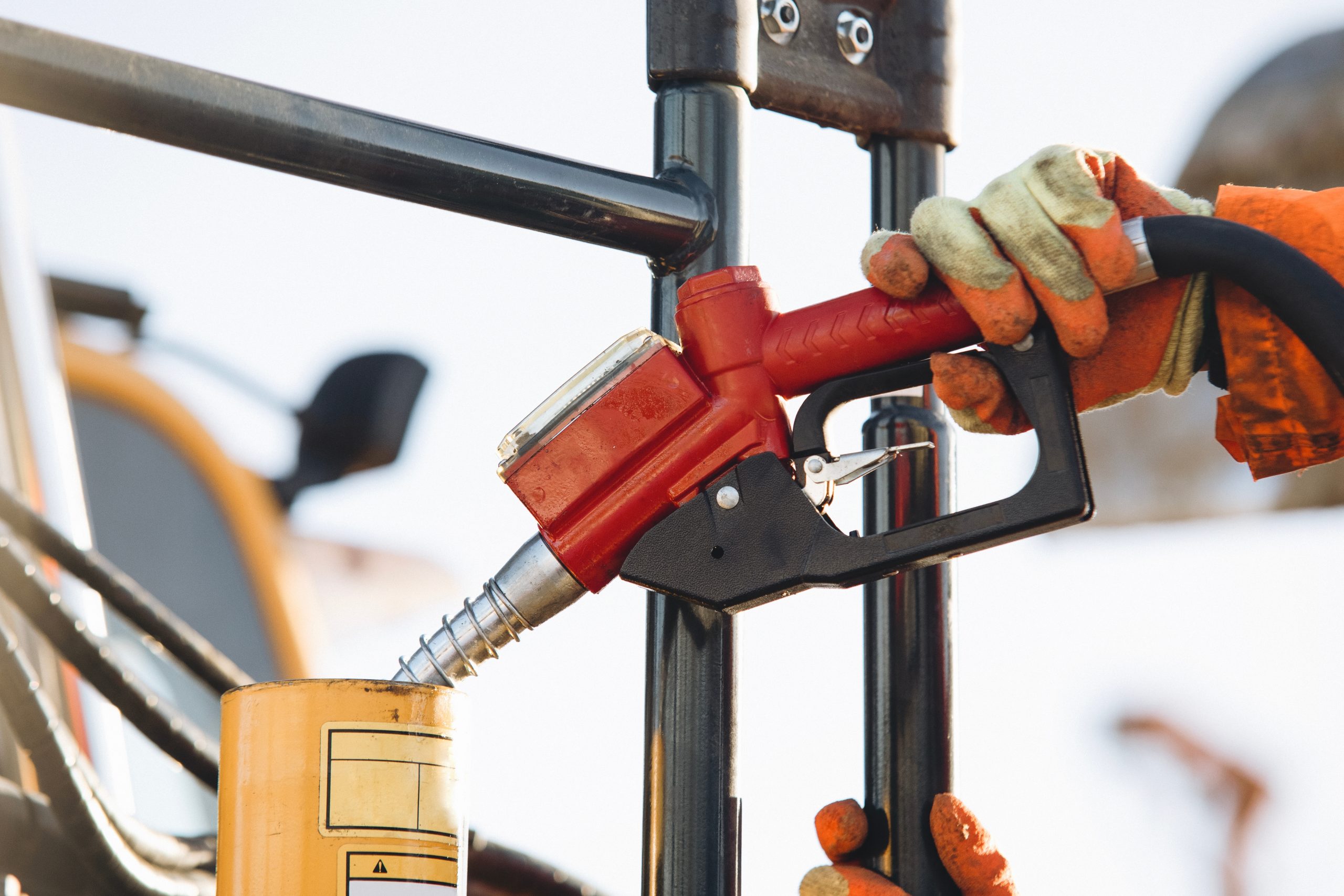 Closeup of refuelling machinery with a fuel pump at a construction site.