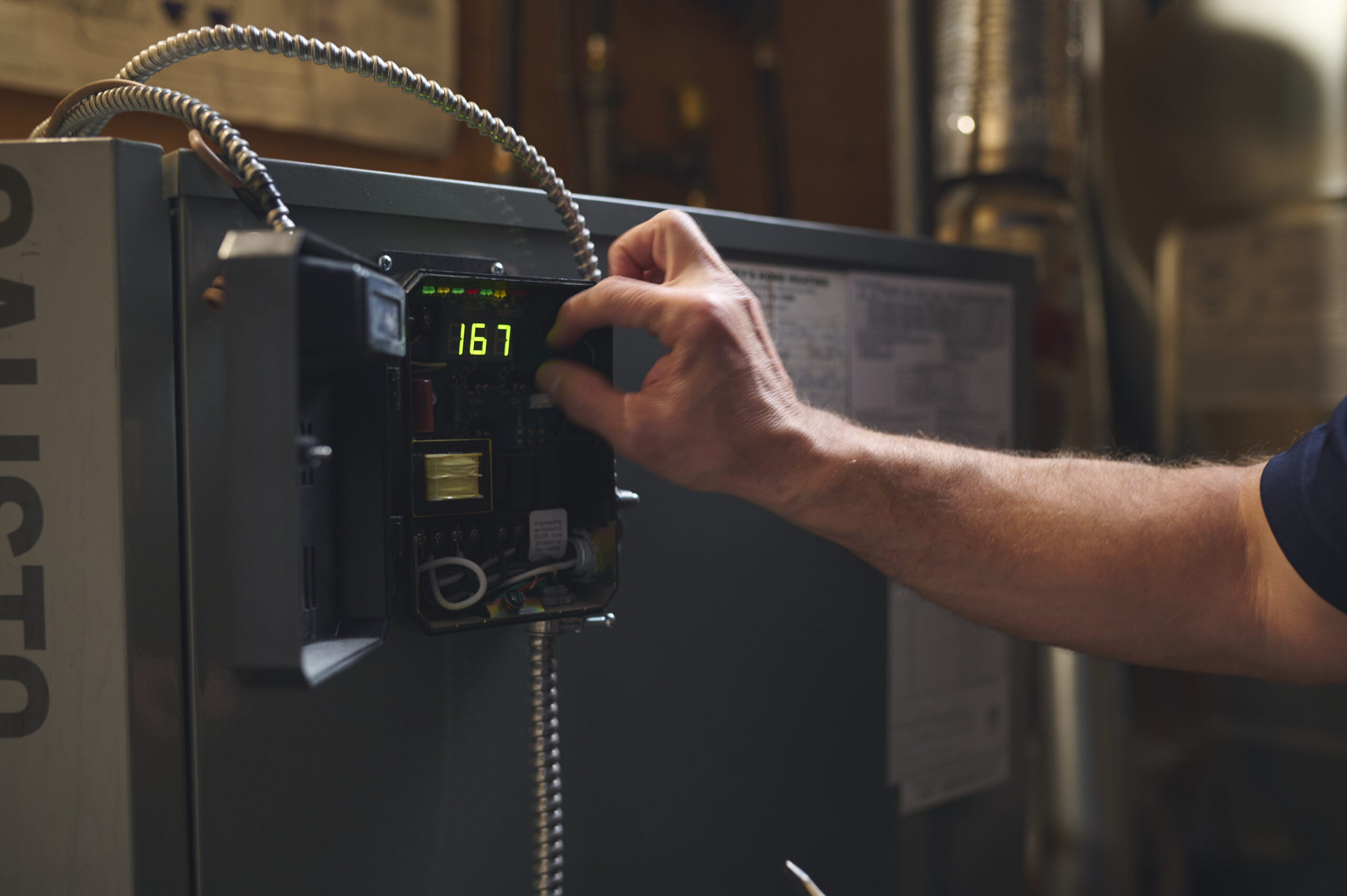 Closeup of a heating oil unit being adjusted.