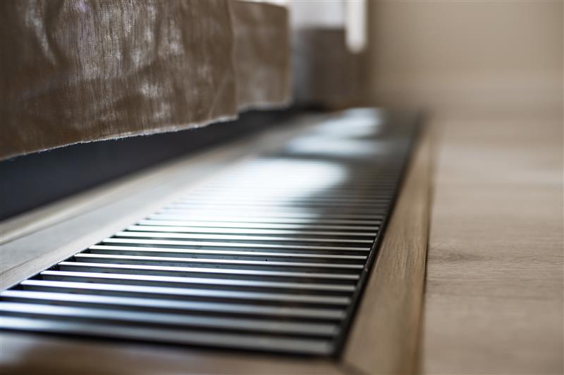 A closeup of an air vent in the floor of a residential home.