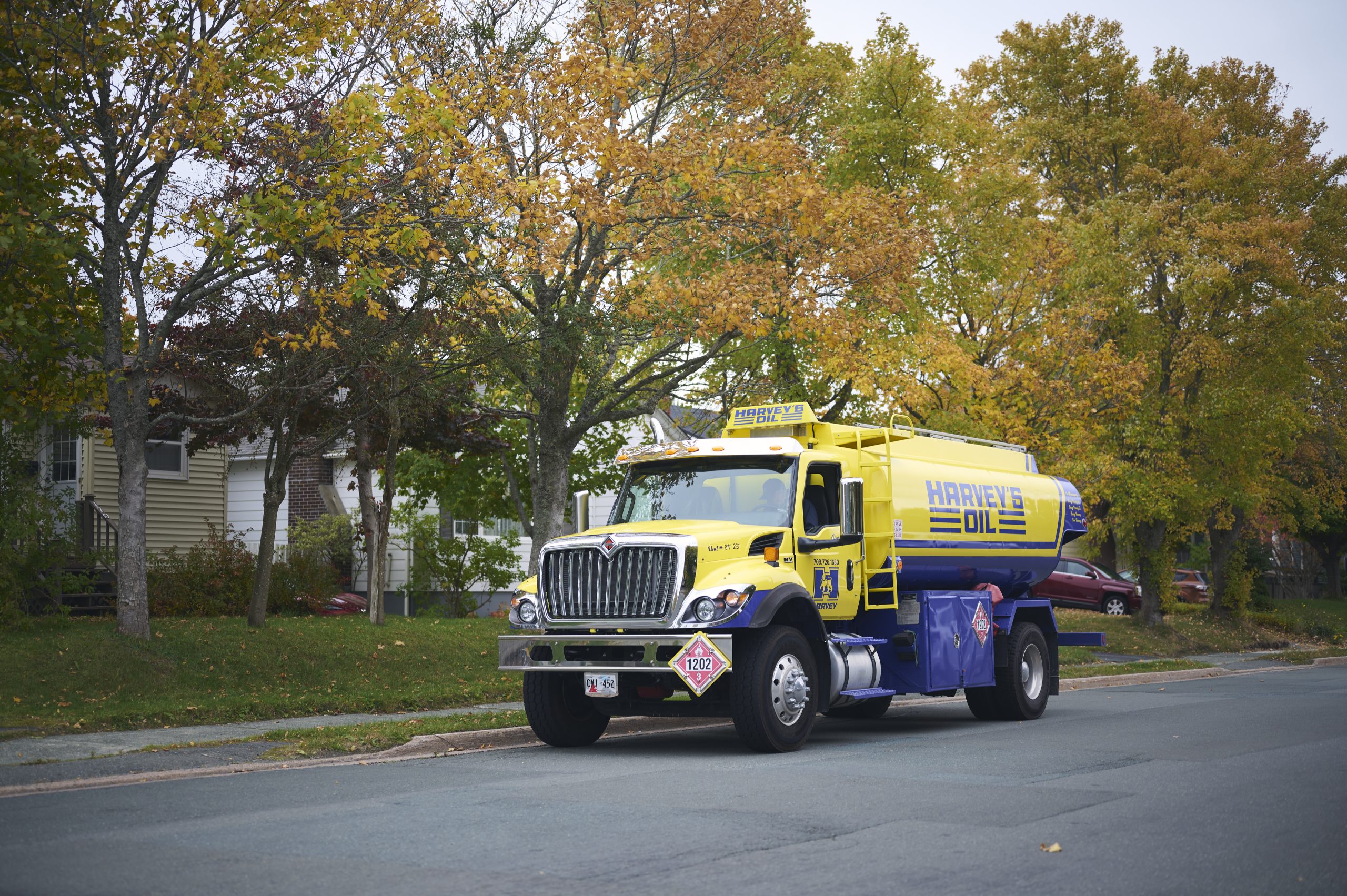 Harvey's retro-style fuel truck, parked on thee side of the road in a residential neighbourhood.