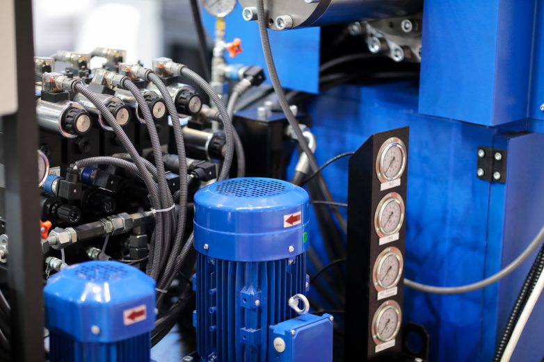 Closeup of hydraulic and electrical equipment; industrial manufacturing machine.