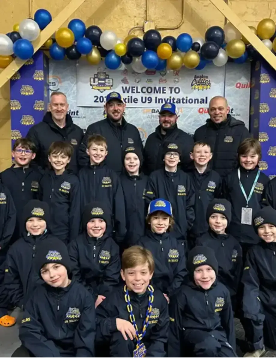 A group photo of a youth hockey teams that is sponsored by Harvey's, at the 2025 Exile U9 Invitational.